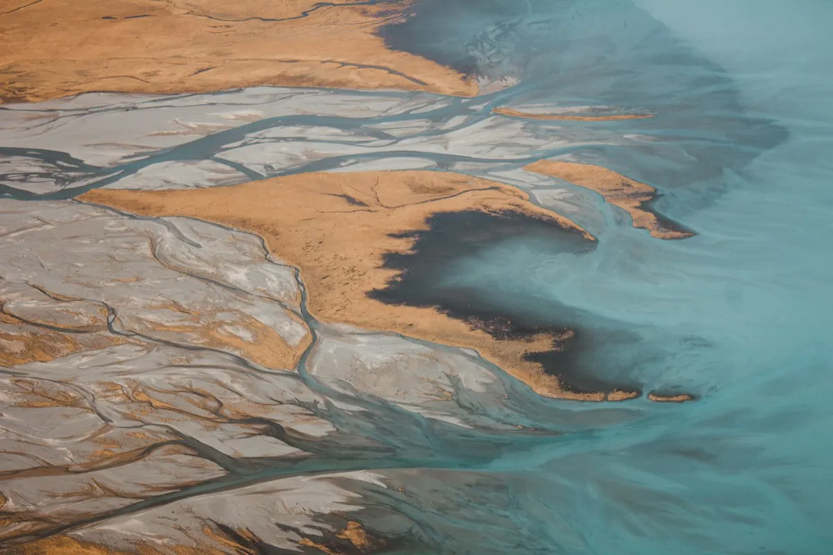 An aerial view of rivers and mountains near Lake Tekapo, New Zealand
